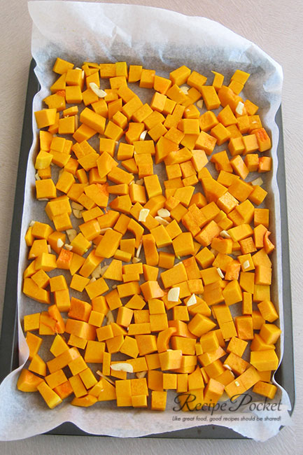 Pumpkin and garlic on oven tray.