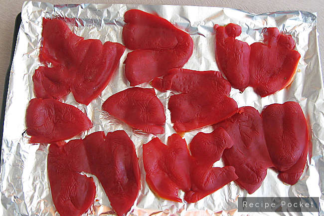 Red capsicum on foil paper ready for roasting.
