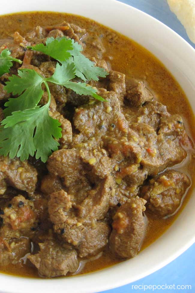 Lamb rogan josh garnished with fresh coriander.