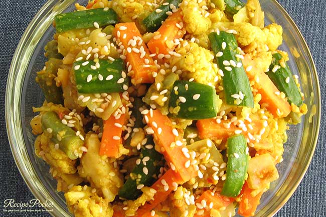 Top view of homemade Indonesain achar with carrots, cucumber, cauliflour,peanuts and seasame seeds.