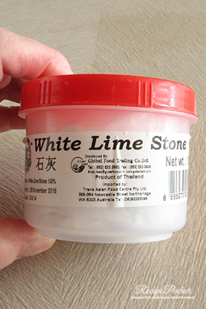 Container of white lime stone paste.