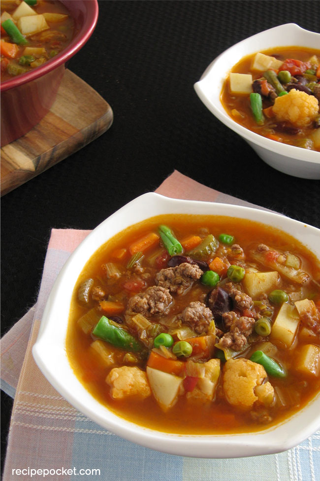 Top view of easy vegetable and beef soup in a white bowl.