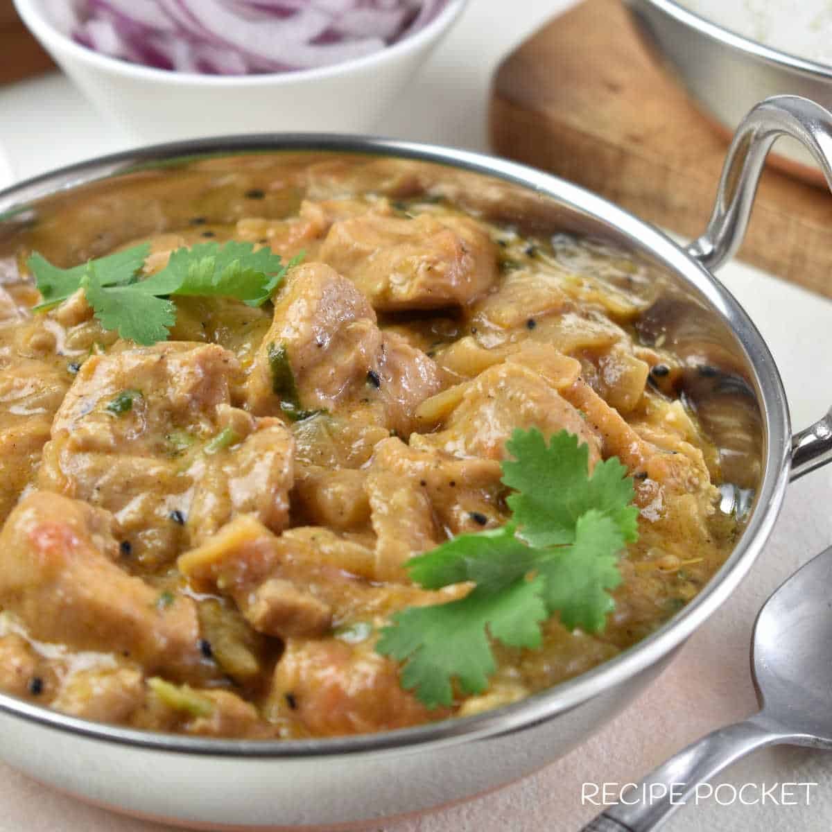 Closeup of chicken curry in a Balti pot.