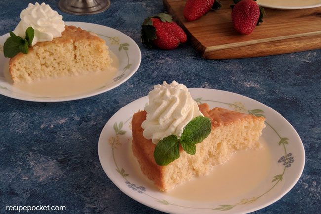 Three milk cake decorated with cream and mint leaves