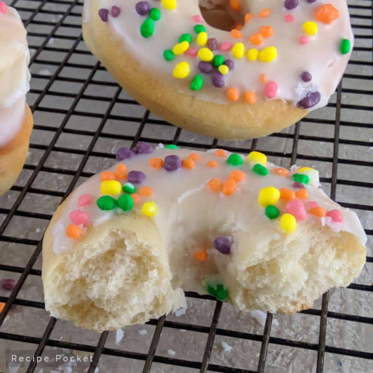 Donuts on a cake rack.