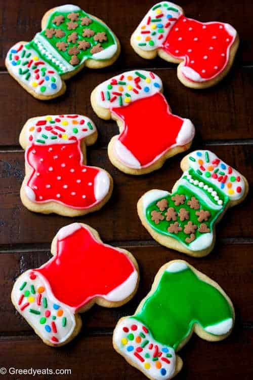 Red and green cookies on a black background.