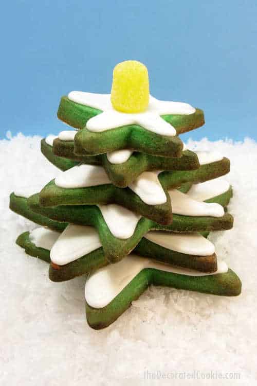A stack of green star cookies with white icing.