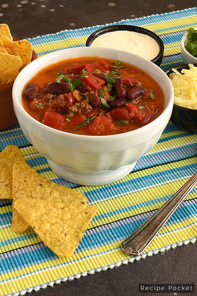 Beef chilli bean soup with corn chips, sour cream and cheese.