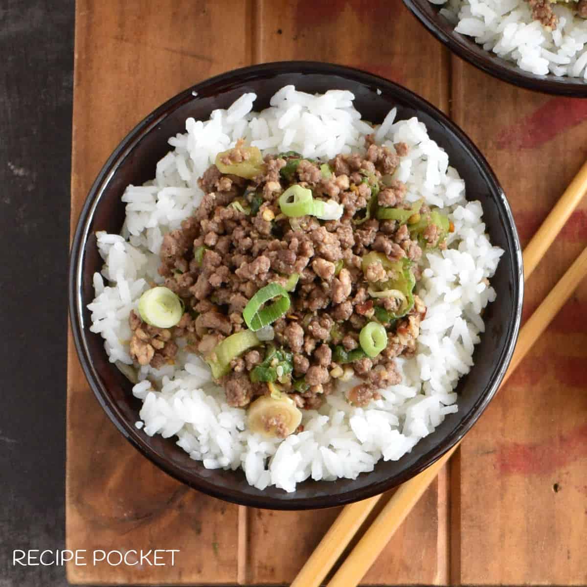 Top down view of ground beef on white rice.