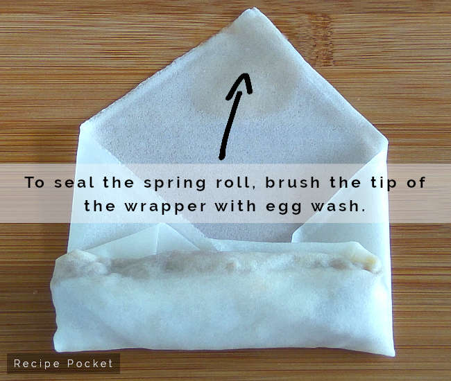 Moisten tip of spring roll wrapper to secure in place.