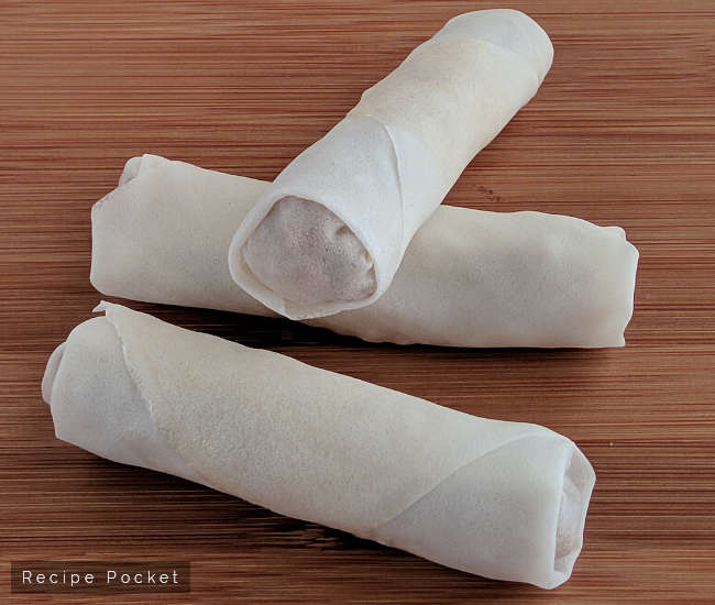 Rolled pork spring rolls ready for deep frying.