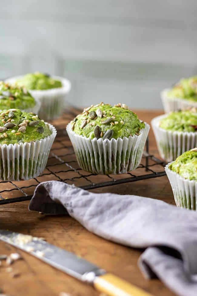 Vegetarian kale muffins on a wooden board.