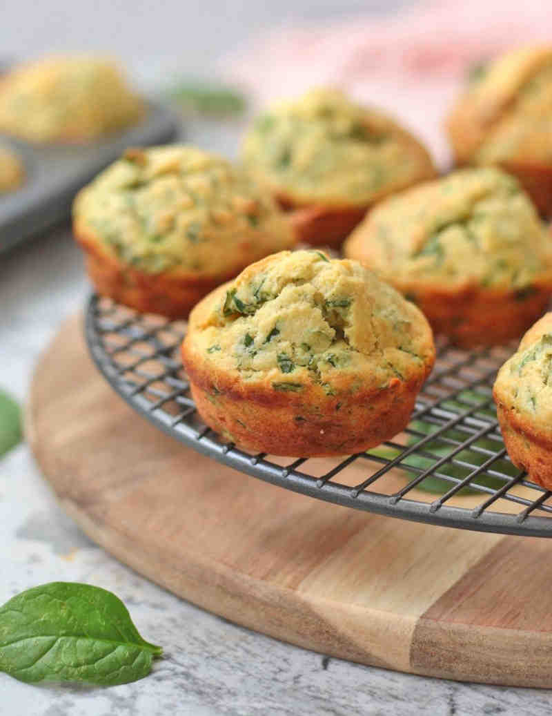 Spinach and cheese muffins on a wire rack.