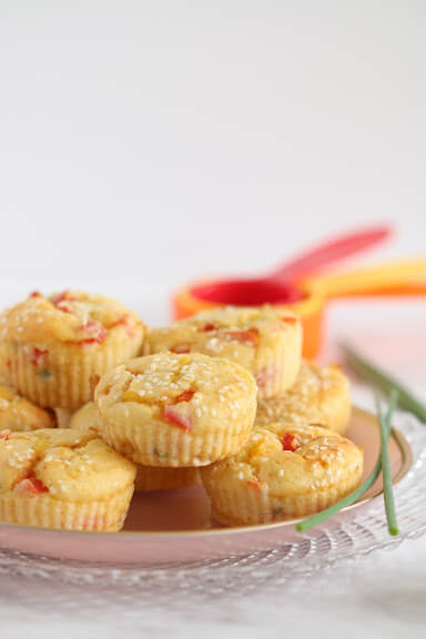 Corn muffins on a pink plate.