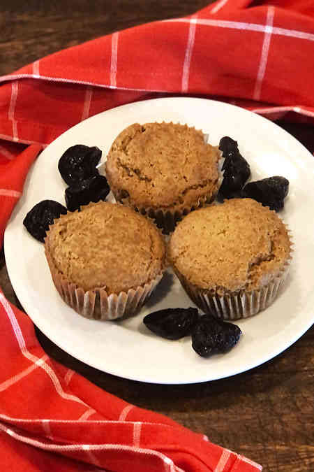 Three muffins and a white plate.