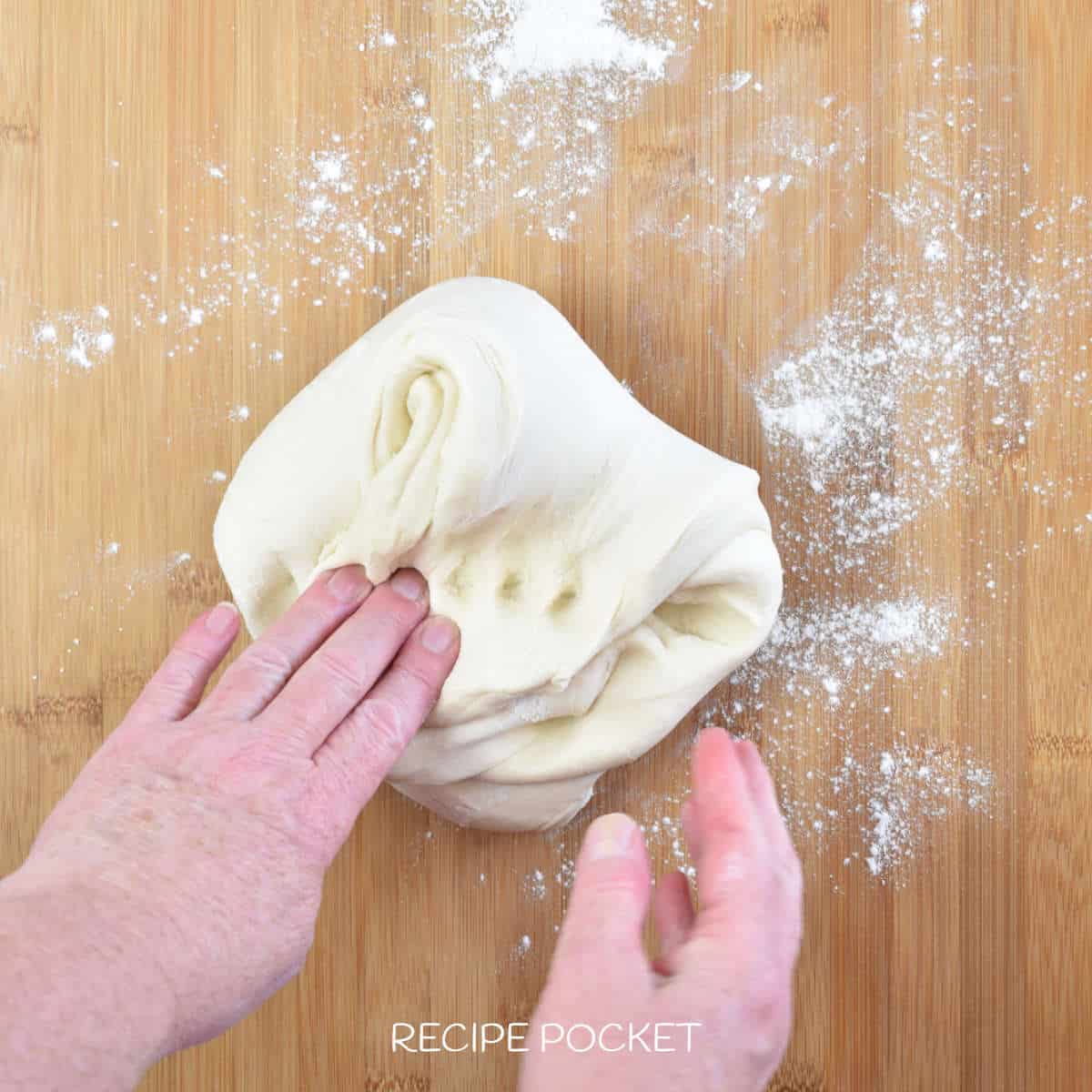 A hand kneading dough.