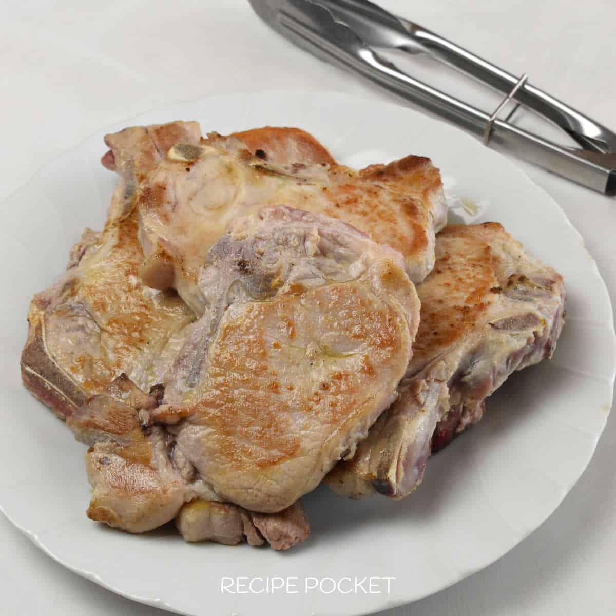 Pork chops on a plate.