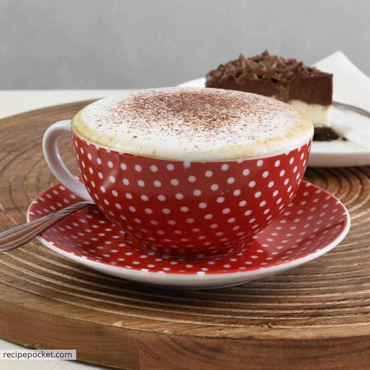 Homemade cappuccino in a red cup.