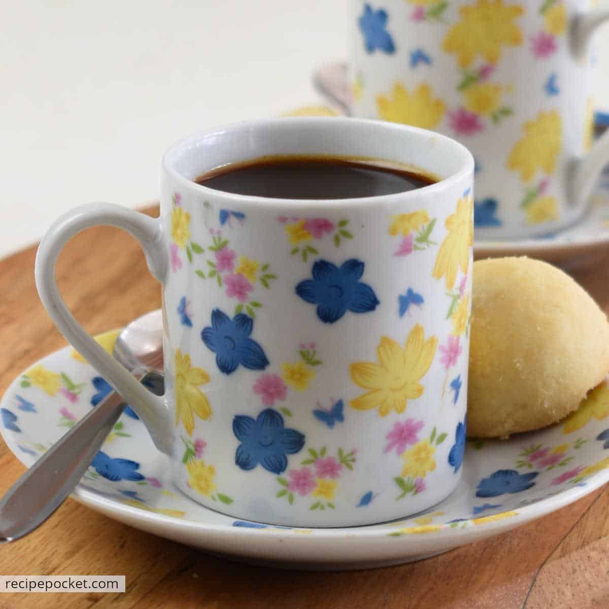 Espresso made with instant coffee in floral espresso cups.