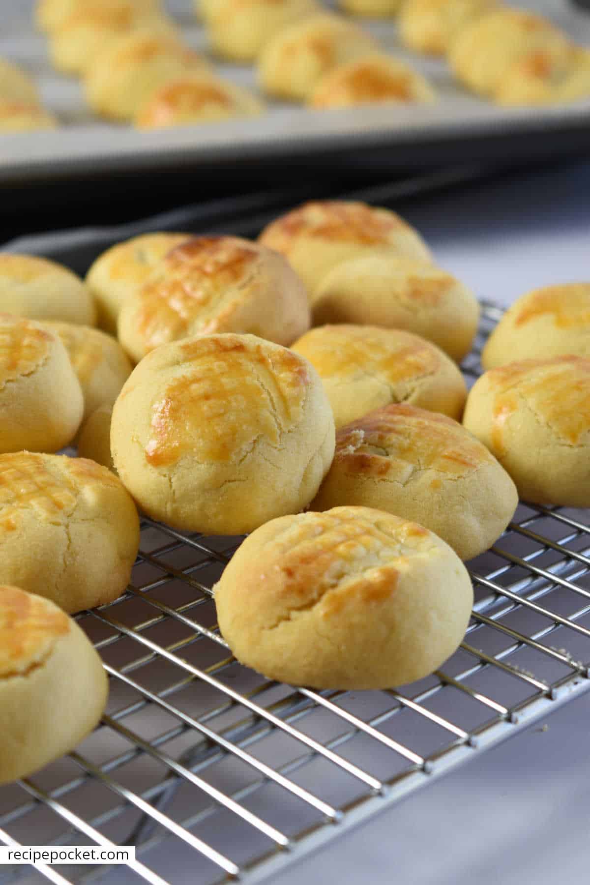 Pineapple tarts cooling on a wire rack.