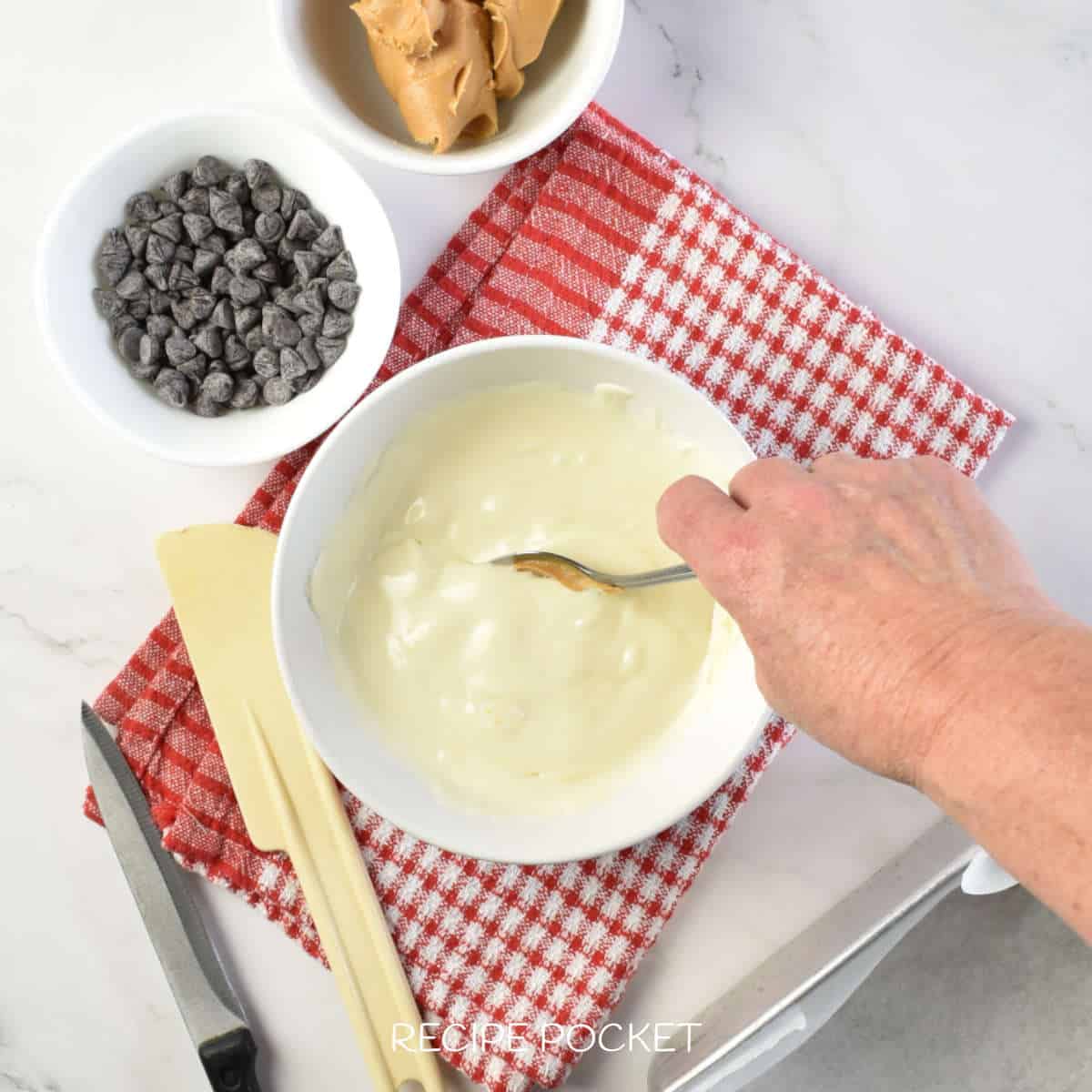 Melted white chocolate in a bowl.
