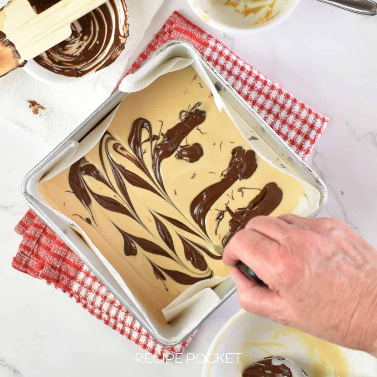 Image showing the making of swirl decorations on a chocolate fudge. mixture.