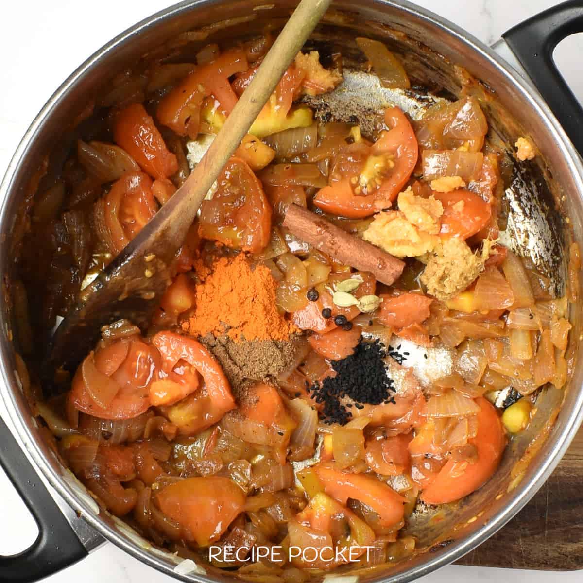 Cooked onion and tomato in a pan with spices.