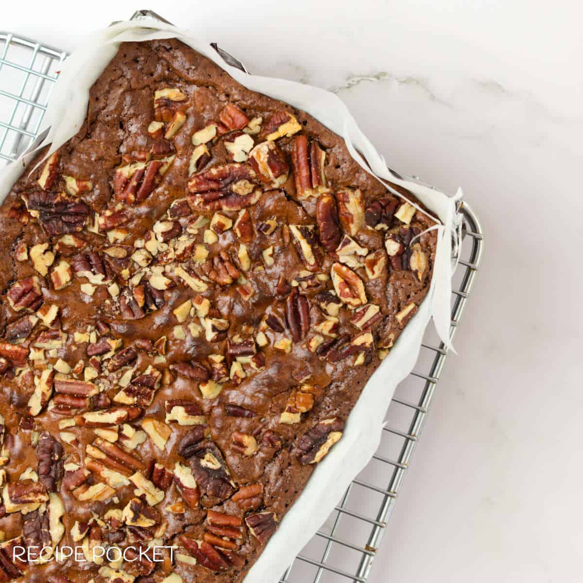 Baked chocolate orange brownie in a baking tin.