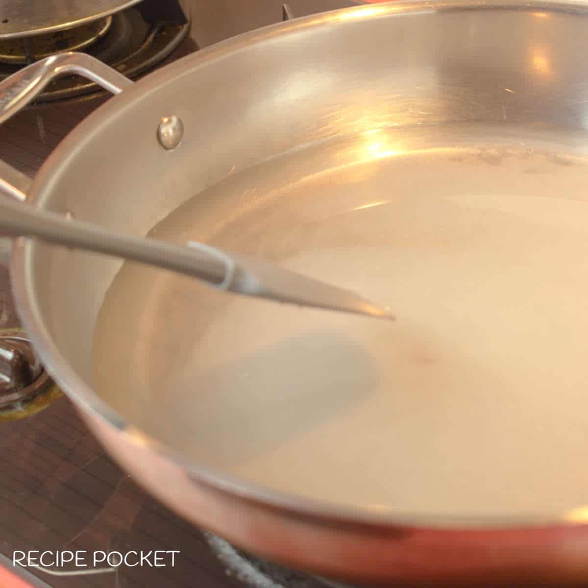Sugar syrup in a skillet.