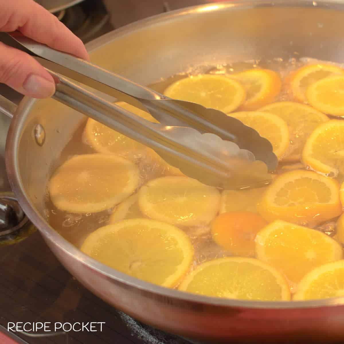 Orange slices in hot sugar syrup.