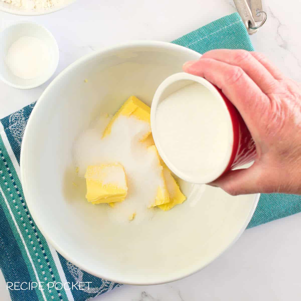 Butter and sugar in a bowl.