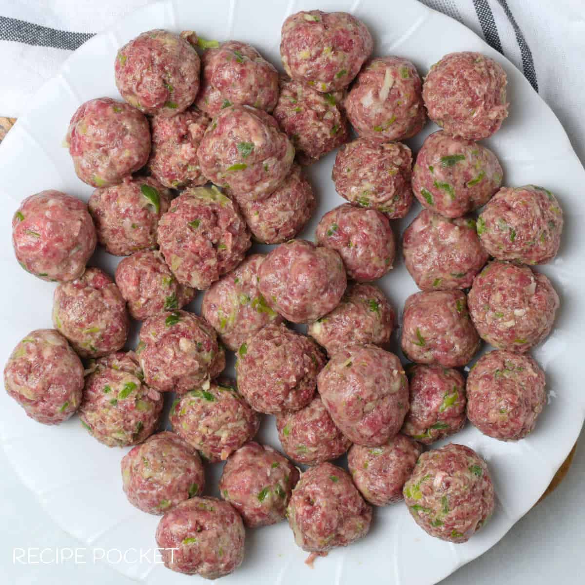 Shaped bakso meatballs on a white plate.
