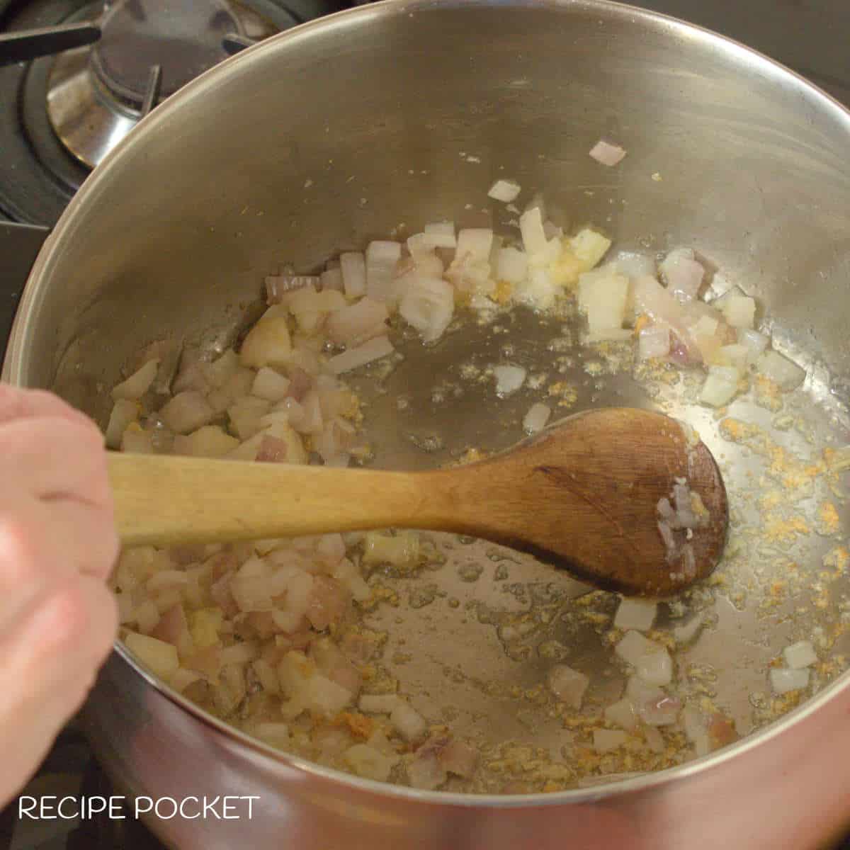 Onions frying in a saucepan.