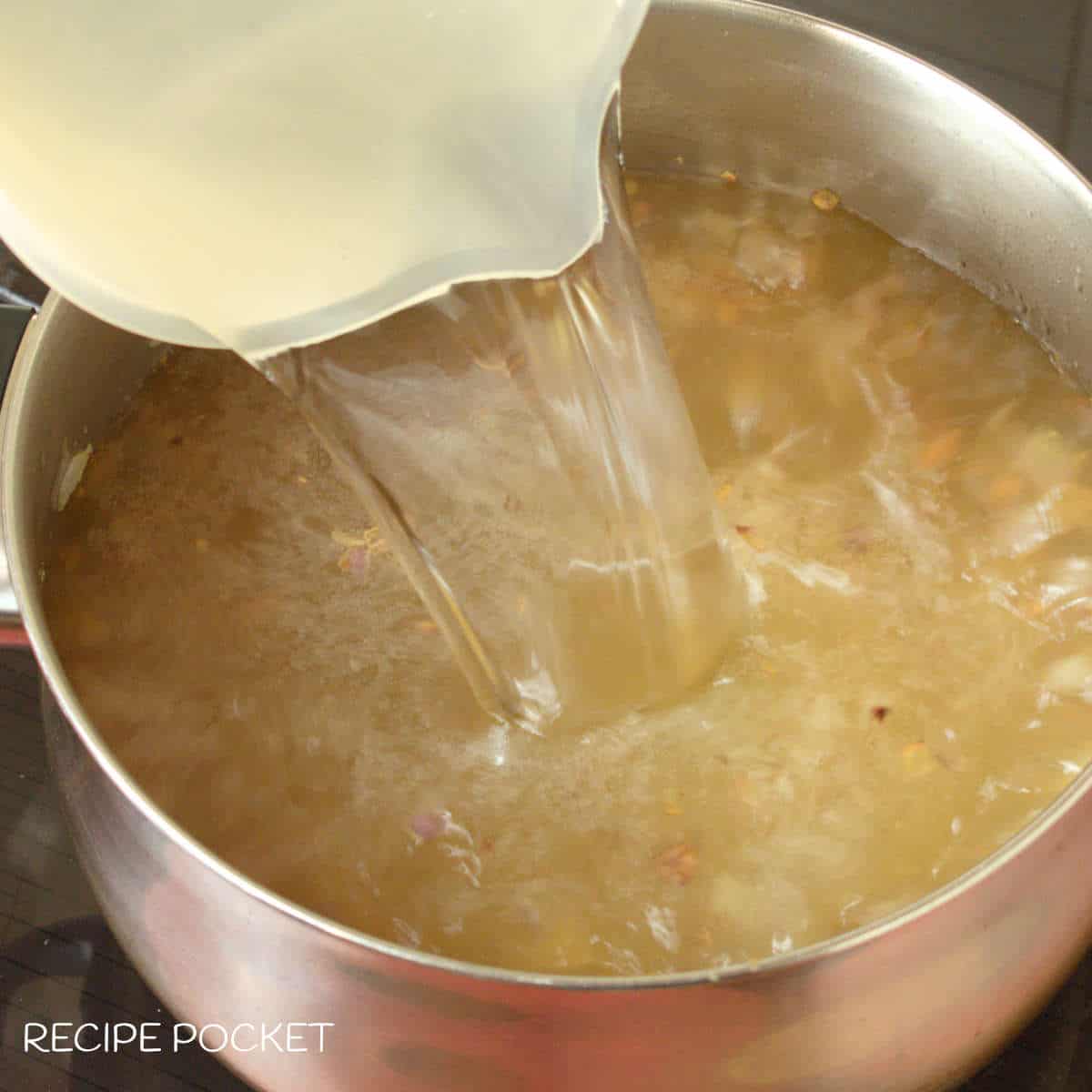 Water pouring into a saucepan.