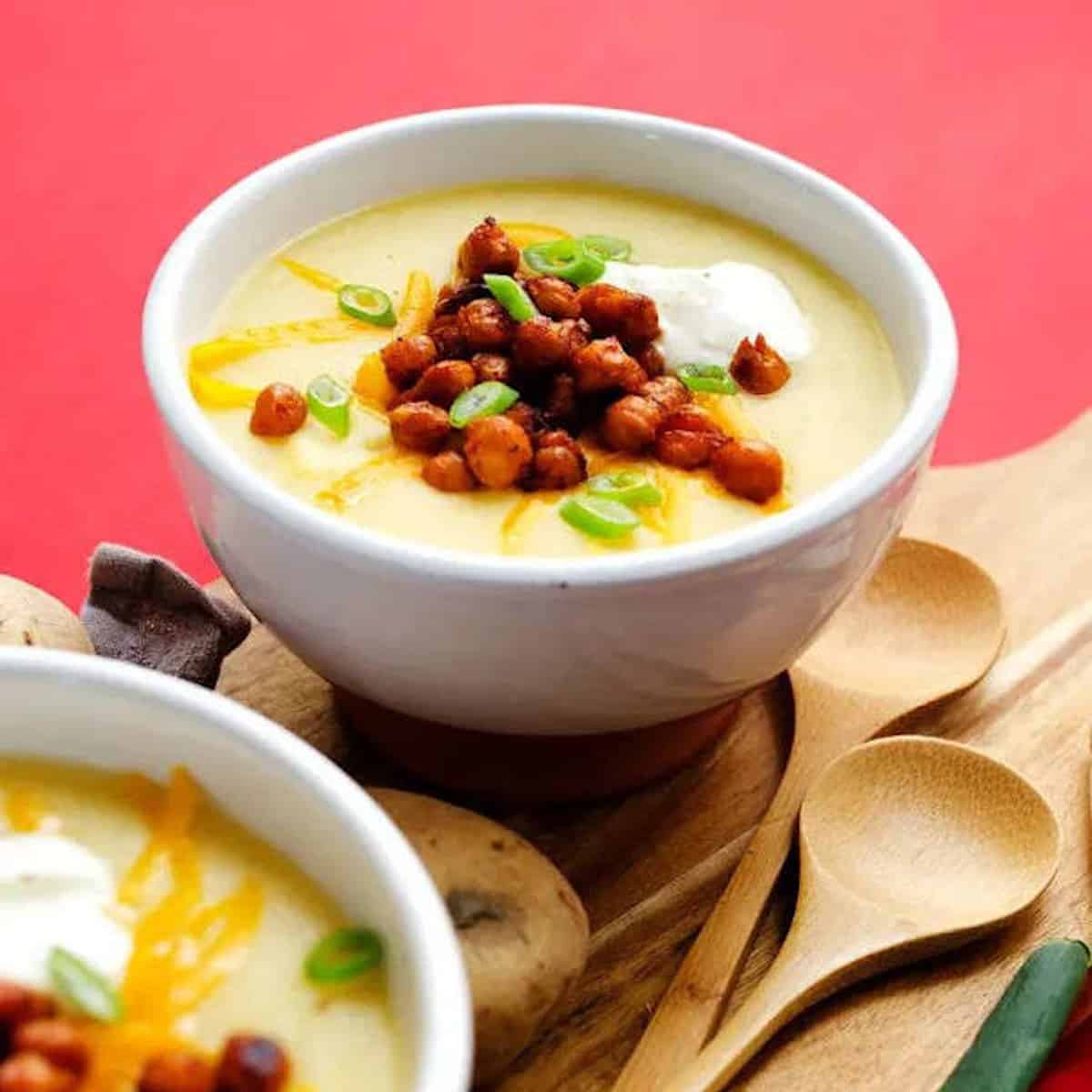 Potato and chickpea soup in white bowls.