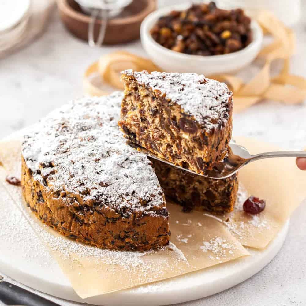 Slice of fruit cake and a cake server.