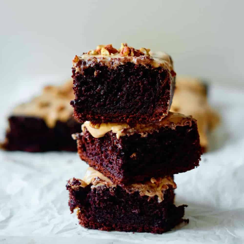 Three pieces of chocolate cake stacked on top of each other.