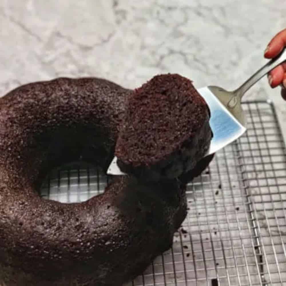 Chocolate rum cake on a cake rack.