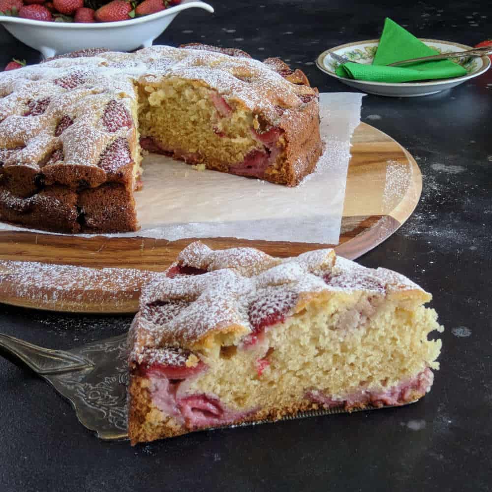 A slice of fresh strawberry cake on a cake slice.