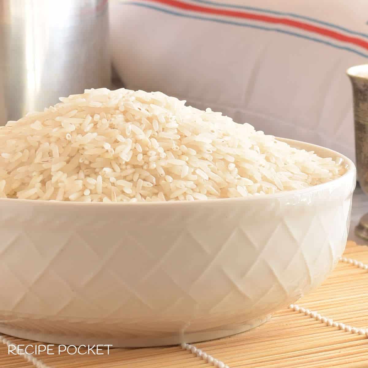 A white bowl with uncooked basmati rice.