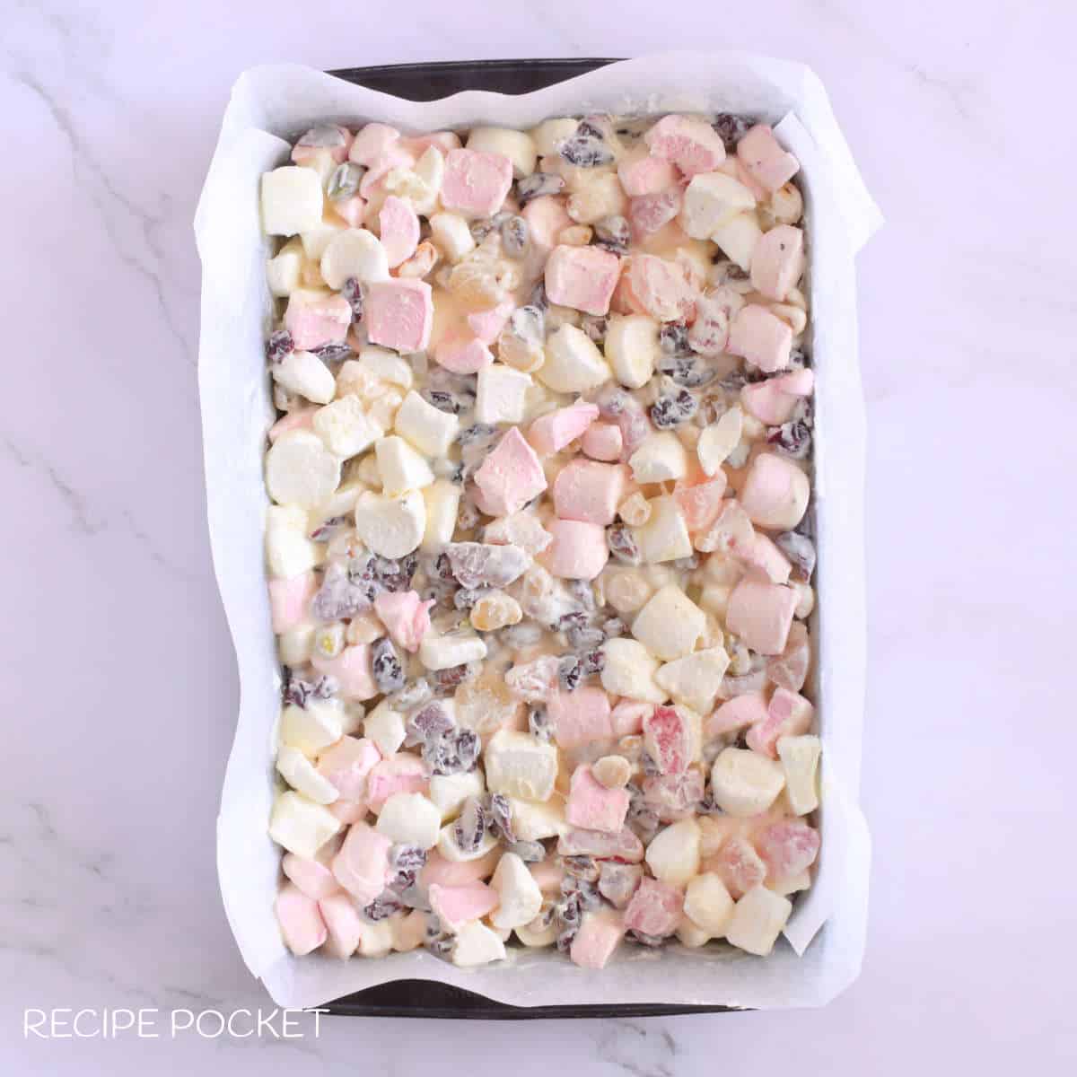 White chocolate rocky road mixture in a a baking tin.