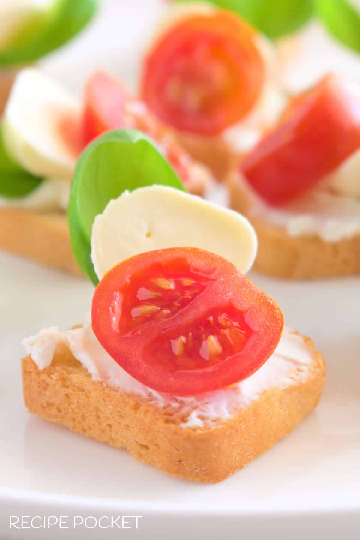 A close up of one caprese crostini.