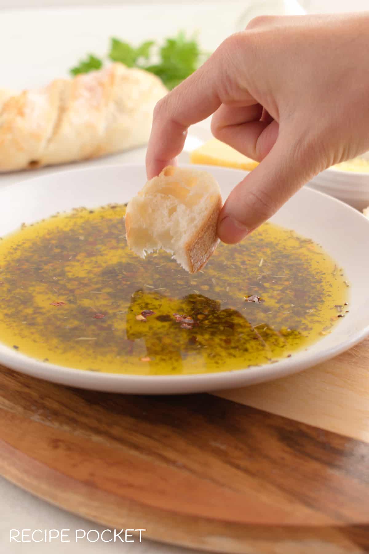 A piece of bread dipped into Italian bread dipping oil.