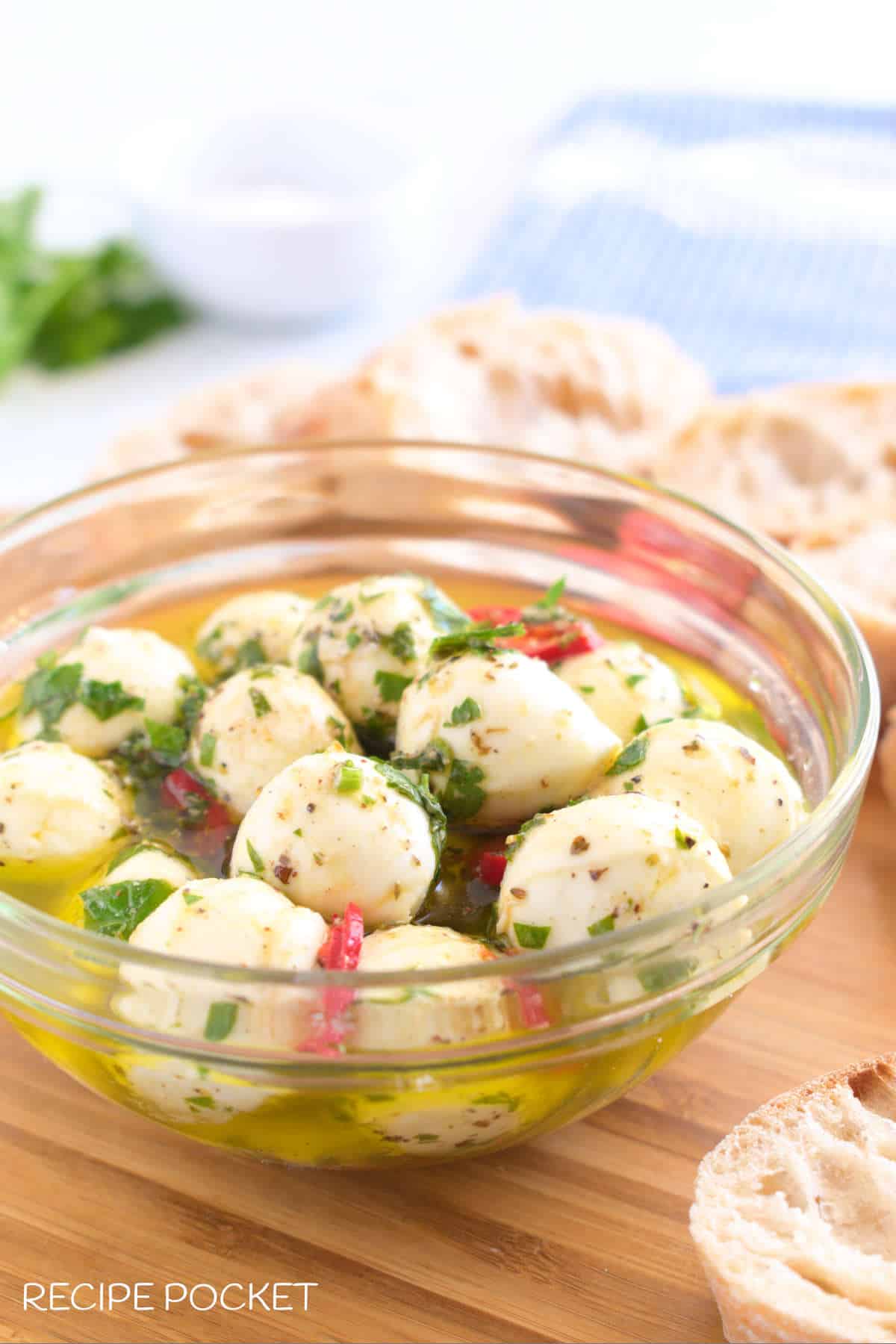 Marinated mozzarella balls in a glass bowl.