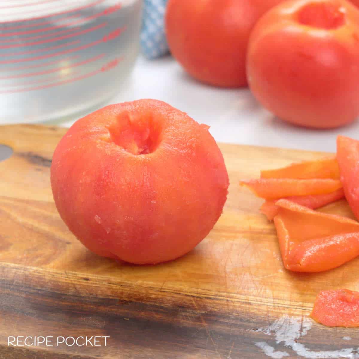 Featured image for article on how to peel a tomato. Picture of a peeled tomato.