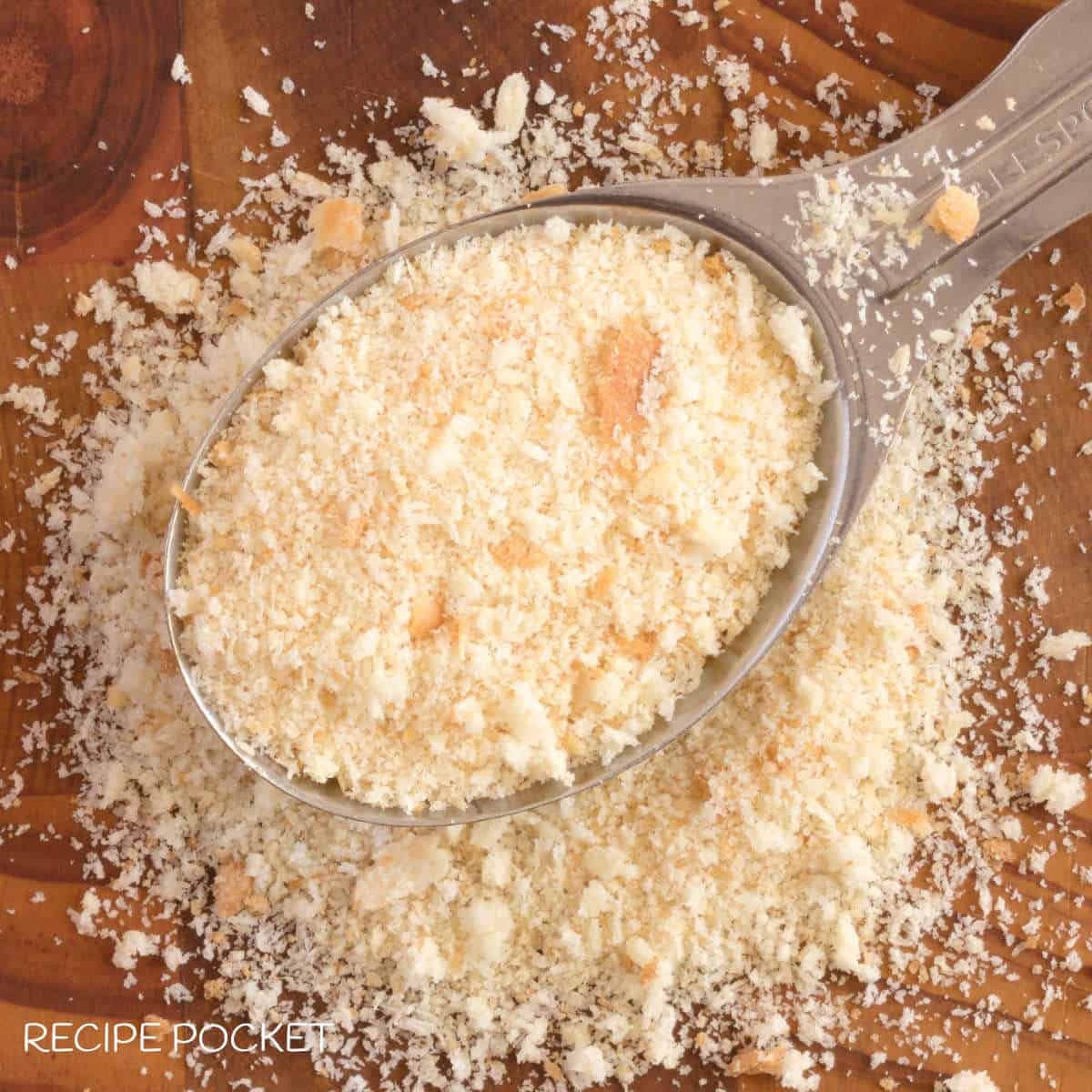 Top down image of homemade breadcrumbs in a spoon.