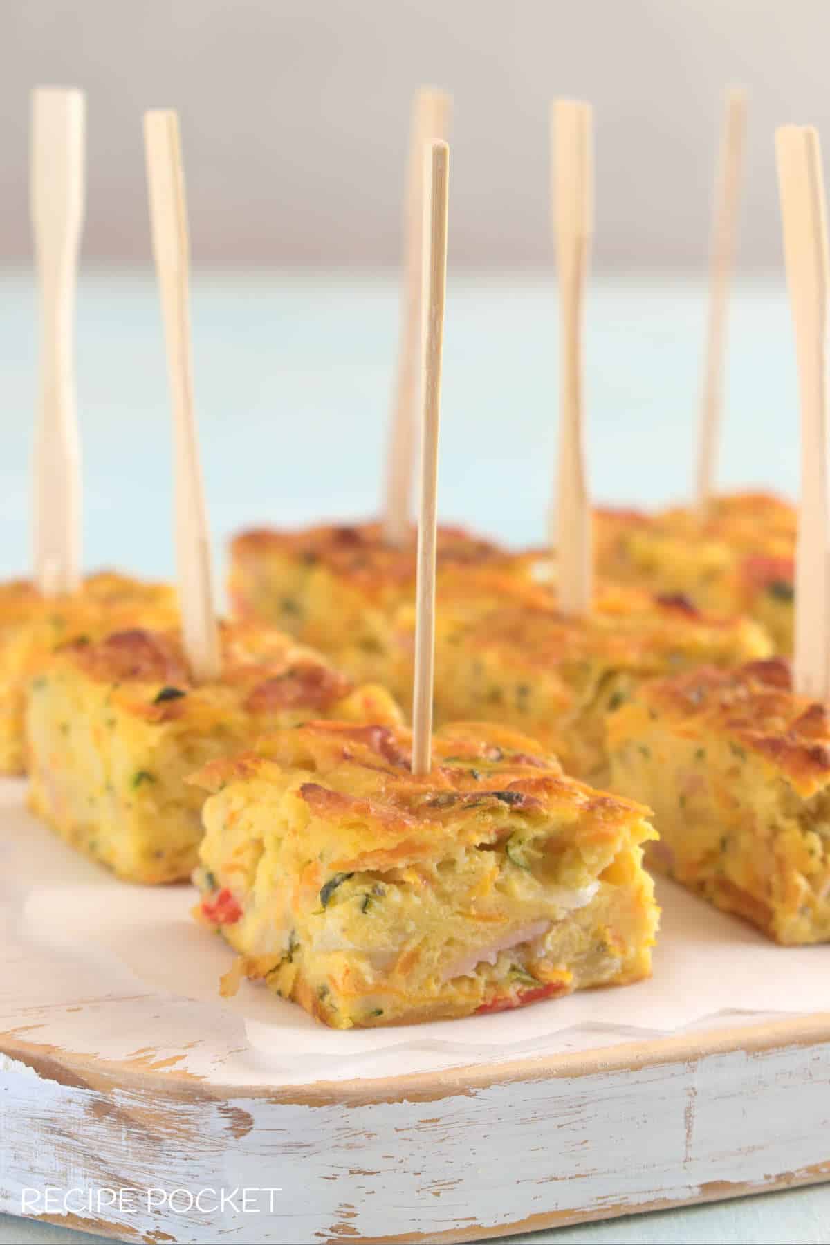 Bite sized  pieces of zucchini and carrot slice on cocktail skewers.
