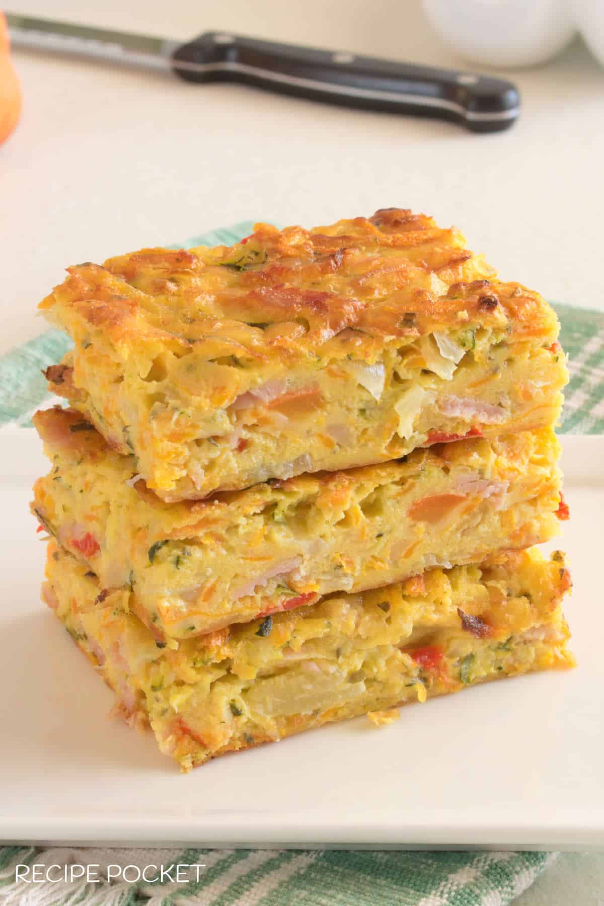 Three pieces of zucchini slice on a white plate.