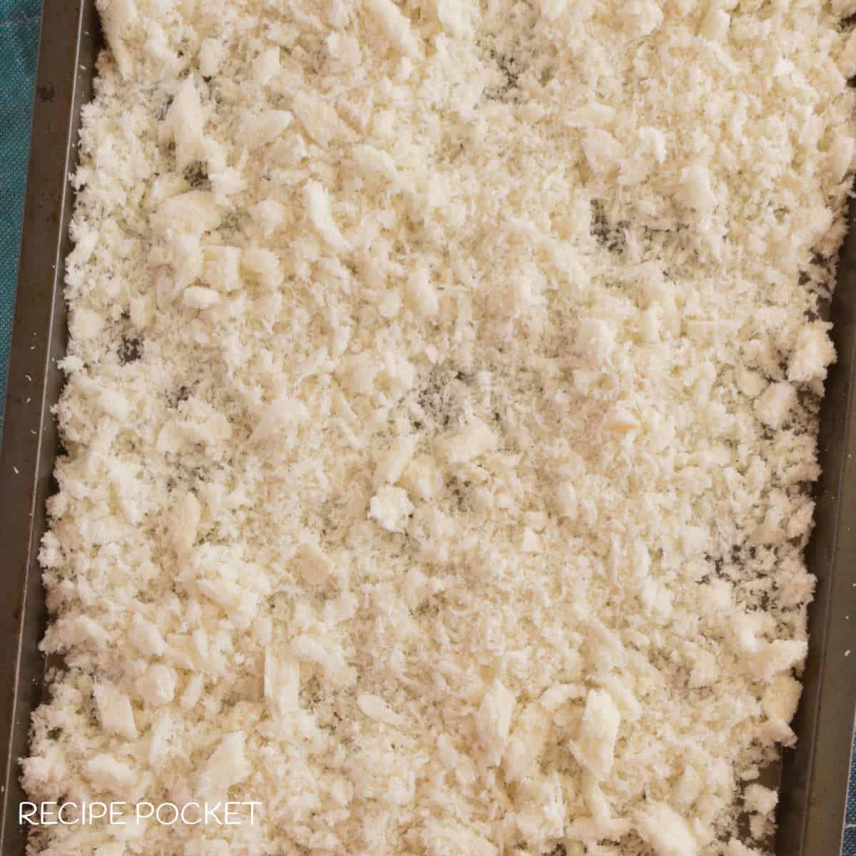 Fresh bread crumbs on a baking tray.