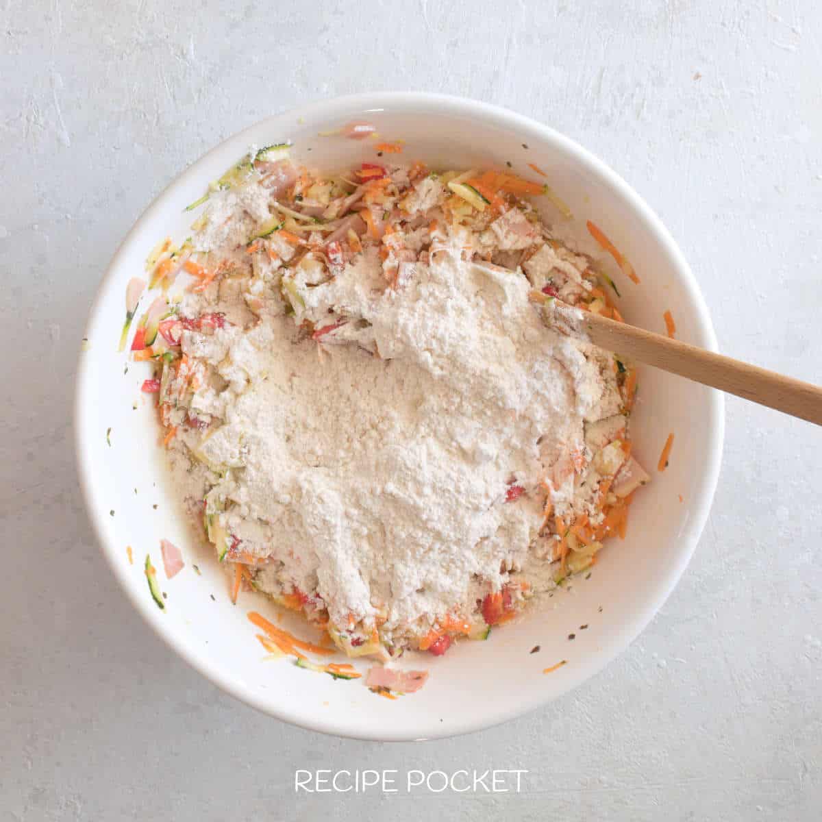 Flour is added to the zucchini mixture.